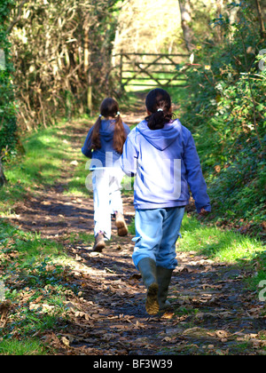 Two young girls along the woodland path. Stock Photo