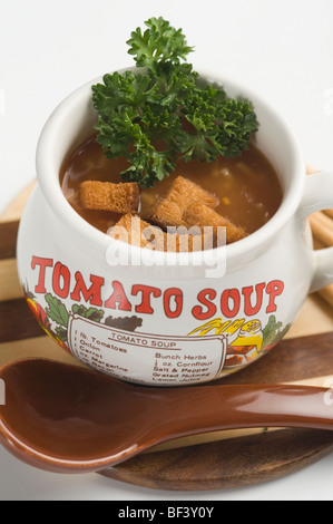 Close-up of a cup of tomato soup with bread cubes Stock Photo