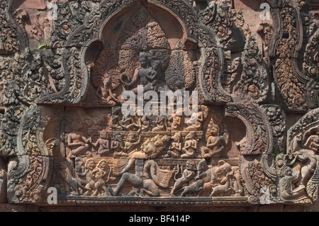 Detail from Banteay Srei, the citadel of the women or beauty, famed for its intricate red sandstone carvings of mythical creatures like Kala. Stock Photo