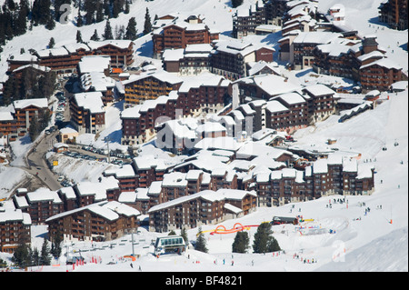 Belle Plagne altitude ski resort village with skiers enjoying apres ski ...