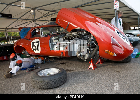 1961 Jaguar E-Type being worked on in the paddock by mechanic. RAC TT entrant at the 2009 Goodwood Revival, Sussex, UK. Stock Photo