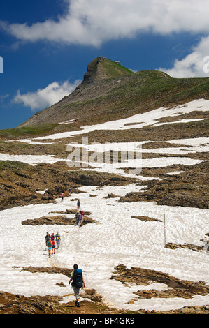 Hikers crossing a snowfield on their way to the Faulhorn summit, Bernese Oberland, Switzerland, Europe Stock Photo