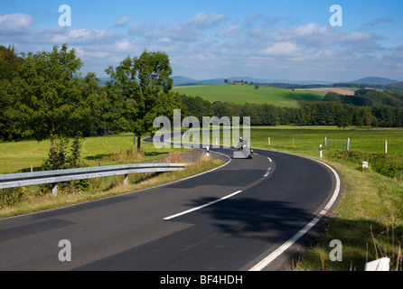 Motorcyclist on a winding country road, Germany, Europe Stock Photo