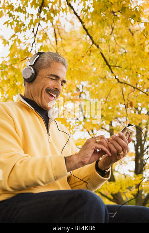 African man listening to mp3 player Stock Photo