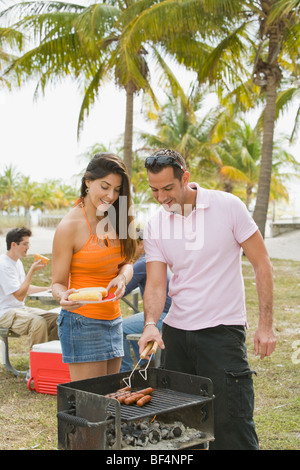 Hispanic friends enjoying barbecue Stock Photo