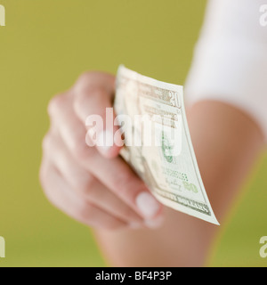 Woman holding twenty dollar bill Stock Photo