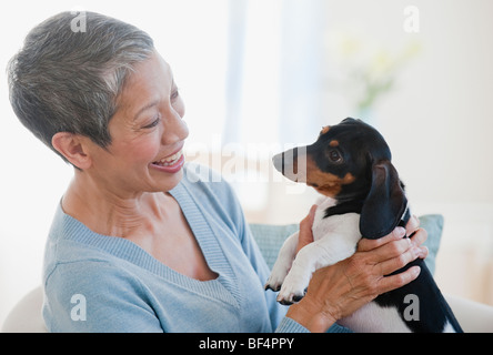 Chinese woman holding dachshund Stock Photo