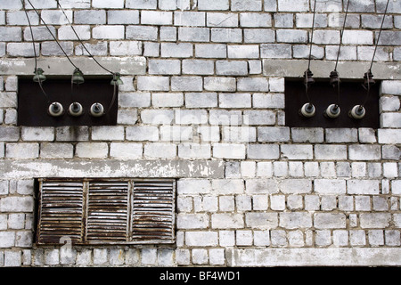 Industrial electricity cabling and ventilation on brickwall Stock Photo