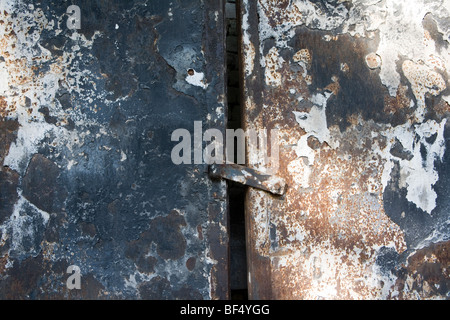 Close up of corroded metal door at abandoned industrial site, Russia Stock Photo