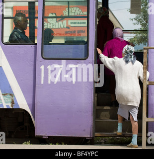 Woman getting on to tram, Russia Stock Photo