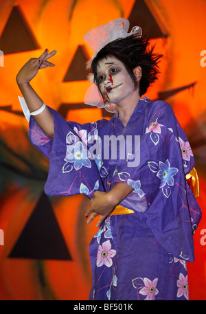 Young girl dressed in a Japanese Kimono performing at a Halloween costume festival Thailand Stock Photo