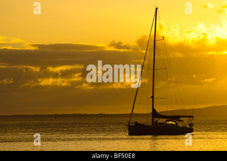 The idyllic yachting life: a luxury yacht anchored during a gorgeous sunset. Stock Photo