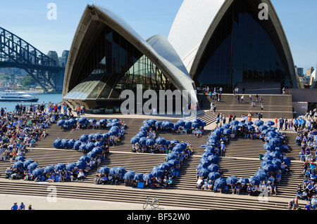 The figure '350' formed by people holding umbrellas. Environmental awareness event; 350.org; protest rally; environmental protest; climate change; Stock Photo