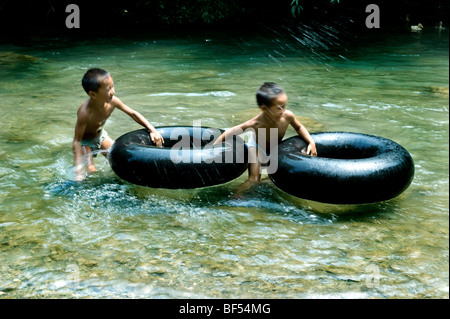 Boys playing in river, Leishan County, Kaili City, Qiandongnan Miao and Dong Autonomous Prefecture, Guizhou Province, China Stock Photo