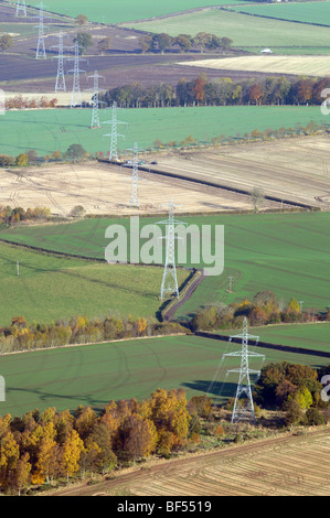 Aerial view of electricity pylons with power lines over agricultural ...