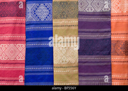 Colourful silk textiles on display at a market stall in Luang Prabang, Laos Stock Photo