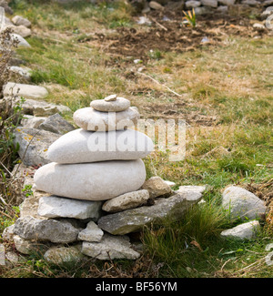 A stack of stones forming a property boundary marker on the isle of Portland Stock Photo