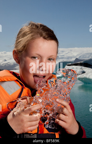 Girl tasting glacial ice,  Jokulsarlon Glacial Lagoon, Iceland Stock Photo