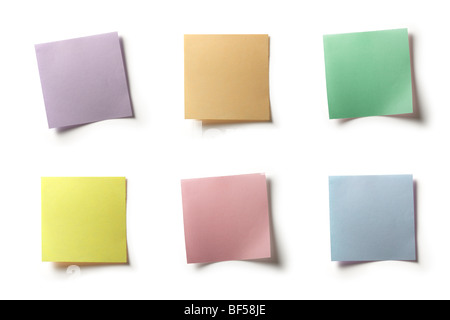 Full-size composite photo of various colored notes (pastel shades). Isolated on white background with light shadows. Stock Photo