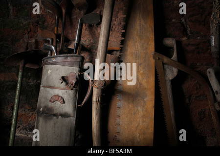 contents of stone shed showing tools,golf clubs and swingball Stock Photo