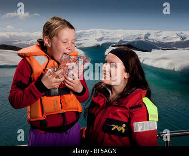 Girl tasting glacial ice,  Jokulsarlon Glacial Lagoon, Iceland Stock Photo