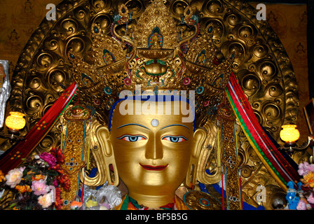 Tibetan Buddhism, the golden face of a Maitreya Lakhang Buddha richly decorated with precious stones, the Buddha of the Future, Stock Photo