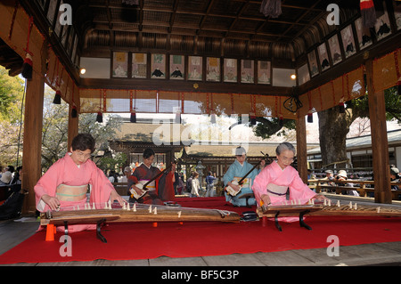 Women playing a Koto, a traditional Japanese stringed musical instrument, Kyoto, Japan, Asia Stock Photo