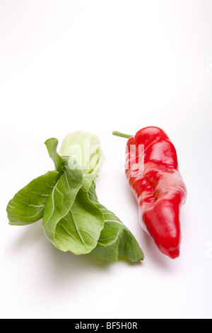 Large sweet red pepper and Pak Choi isolated against white background. Stock Photo