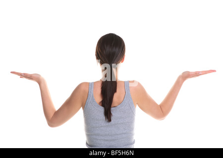 Rear view of a brunette woman doing yoga with her arms outstretched, isolated on a white background. Stock Photo