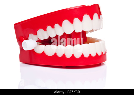 A pair of joke wind up chattering teeth on a pure white background, high resolution photo. Stock Photo