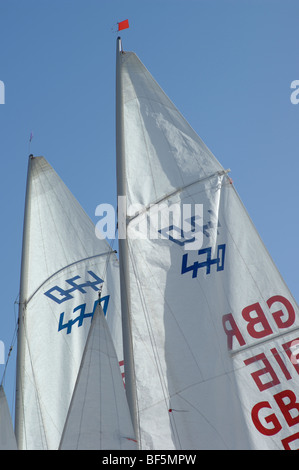 Yacht sails against a blue sky Stock Photo