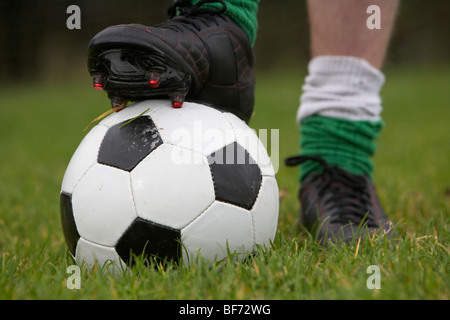 soccer football player with foot on the ball ready to take a kick Stock Photo