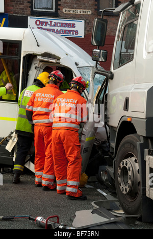 Fire Service Search and Rescue cutting driver out of bus following crash Stock Photo