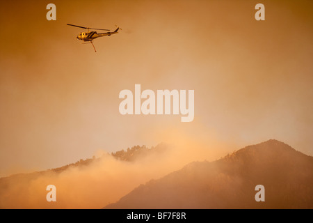 helicopter drops water on the Jesusita Fire amid ash fall and smoke, Santa Barbara, California, United States of America Stock Photo