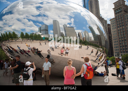 visitors reflect in the Cloud Gate installation, AT&T Plaza, Millennium Park, Chicago, Illinois, United States of America Stock Photo
