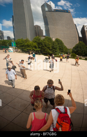 visitors reflect in the Cloud Gate installation, AT&T Plaza, Millennium Park, Chicago, Illinois, United States of America Stock Photo