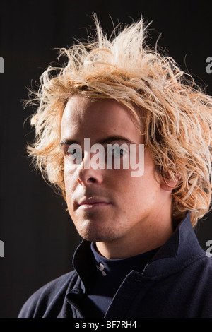 Head and shoulders portrait of a young man posing with a serious expression. UK, Britain Stock Photo