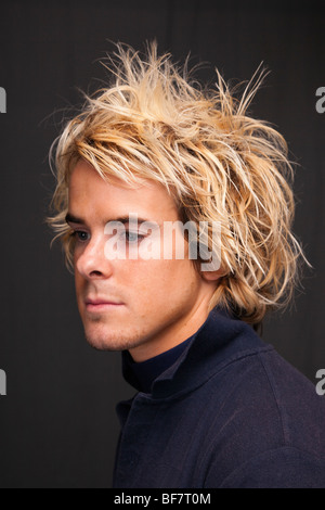 Studio, UK, Europe. Head and shoulders portrait of a young man posing with a pensive expression Stock Photo