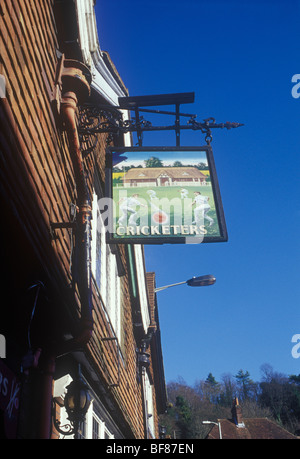 Winchester Hampshire UK Traditional pub sign for Cricketers showing game in progress Stock Photo