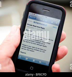 reading a phishing email fraud scam letter on an apple iPhone, UK Stock Photo