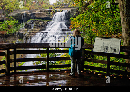 Woman Viewing Brandywine Falls in Cuyahoga Valley National Park in Ohio Stock Photo