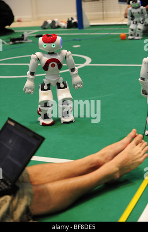 RoboCup 2009, Graz, robot world championship, robotics, humanoid, Nao-robot, shiny eyes, Human-Robot-Interaction Stock Photo
