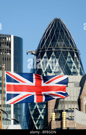 Union Jack flag with the Swiss Re building in the background. City of London. UK 2009. Stock Photo
