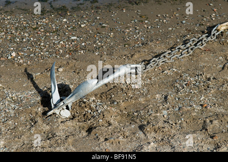 Silver coloured anchor in sand at Luss on the banks of Loch Lomond Stock Photo