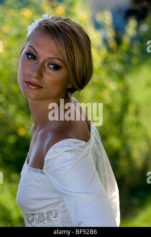 Portrait of the beautiful young bride looking over her shoulder. Stock Photo