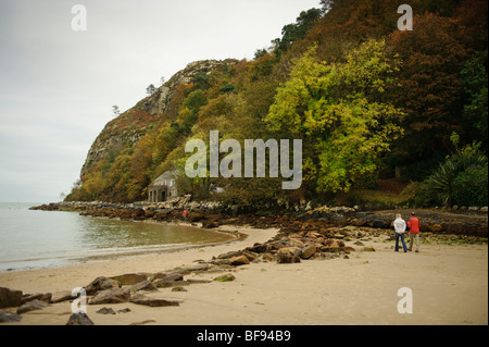 People walking on the beach, October afternoon, Llanbedrog, Snowdonia National Park, Lleyn peninsula, Gwynedd, North Wales, UK Stock Photo