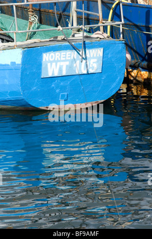 colourful trawlers and fishing vessels moored at Dingle harbour in Ireland, eu Stock Photo