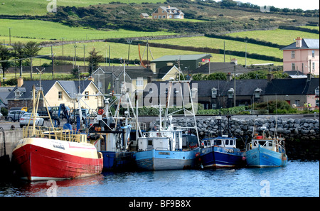 colourful trawlers and fishing vessels moored at Dingle harbour in Ireland, eu Stock Photo