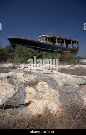 beached abandoned fishing boat in potamos typical small unspoilt fishing village republic of cyprus europe Stock Photo