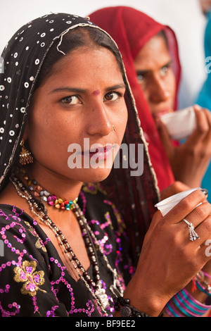 Rajput women drinking chai tea at the Pushkar Mela in Pushkar in Rajasthan India Stock Photo